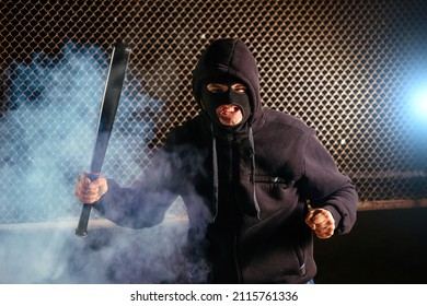 Masked Angry Man With Bat In Smoke