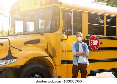 masked bus driver looking at camera outside the elementary school