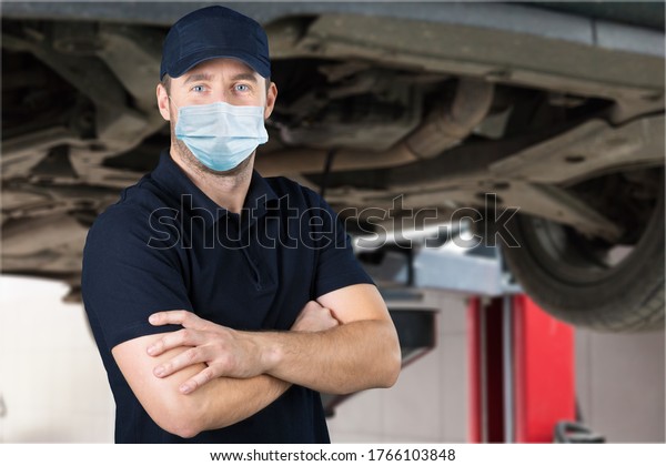 Masked\
car mechanic working during coronavirus\
pandemic