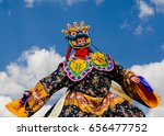 Masked Dancer - 
Bhutan, masked dancer at a traditional monastery festival the Wangdue Phodrang Tsechu A monk in a colorful dress with mask during the tsechu (dance festival) in Wangdue, Bhutan.
