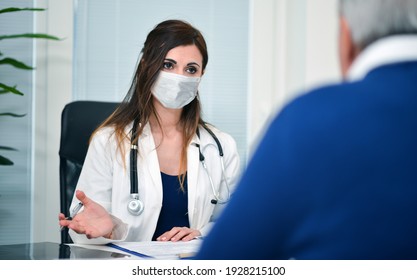 Masked Doctor Talking To A Patient, Coronavirus Covid Concept