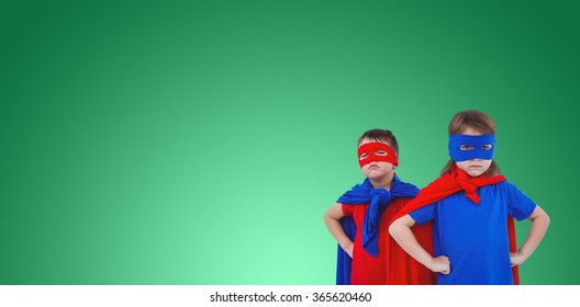 Masked kids pretending to be superheroes against green vignette