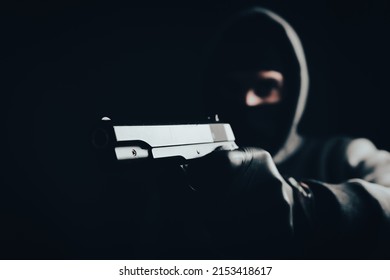 Masked Man Holding A Gun