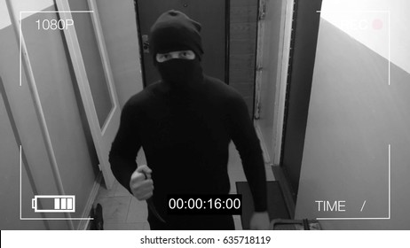 the masked robber burst through the door and threatened with a knife in CCTV camera.
