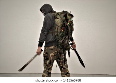 Masked Survivalist Holding Two Machetes