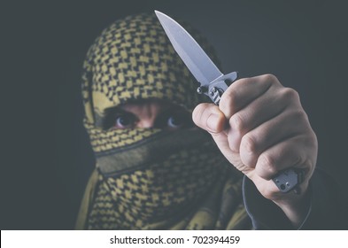 Masked Terrorist Treating With A Knife. Concept Of Terrorism And Violence.