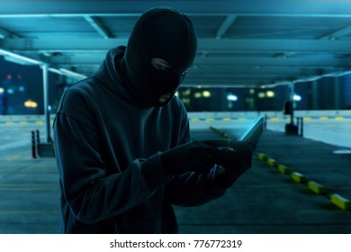 Masked Thief Using Mobile Phone