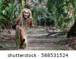 A masked tribesman from the Mah Meri ethnic group strinking a pose. This ethnic group is well known well known for their wood carving skills.