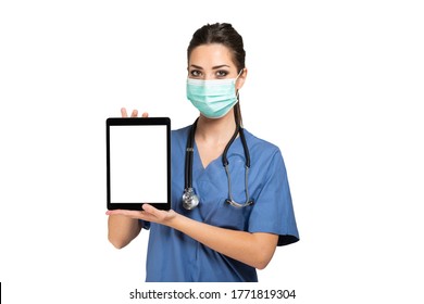 Masked Young Nurse Doctor Using A Tablet, Isolated On White