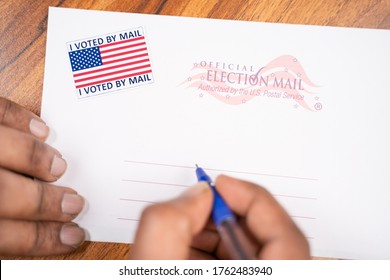 Maski, India - 23, June 2020 : Hands Filling Out Mail Postel Stamp, Concept Of Voted By Mail During US Election.