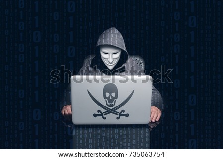 Masking anonymous hacking and using computer to hack passwords. Dark background and binary 0 and 1