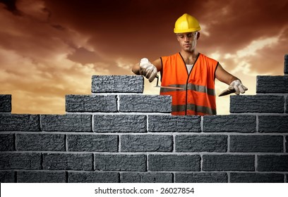 Mason In A Hardhat Building Brick Wall