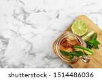 Mason jar of delicious iced tea on marble table, top view. Space for text