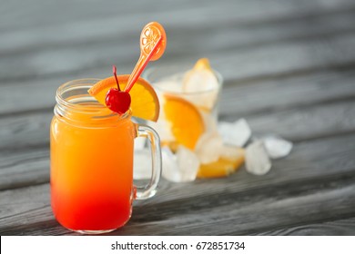 Mason Jar Of Delicious Tequila Sunrise Cocktail On Table