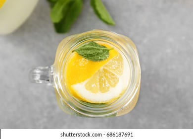 Mason Jar Of Fresh Lemonade On Grey Background