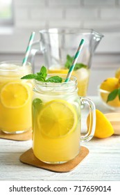 Mason Jar With Fresh Lemonade On Wooden Table