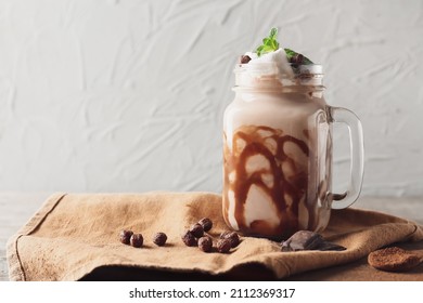 Mason jar of sweet cocoa drink on grunge background