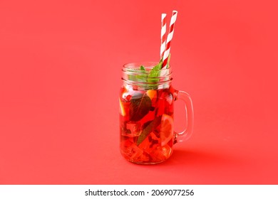 Mason Jar Of Tasty Ice Tea With Fruits On Color Background