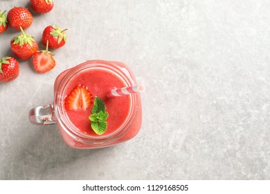 Mason Jar With Tasty Strawberry Smoothie On Table, Top View