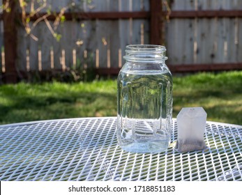 Mason Jar And A Tea Bag On A Patio Table Ready To Make Sun Tea Or Sweet Tea.