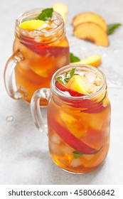 Mason jars of peach tea with ice