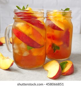 Mason jars of peach tea with ice