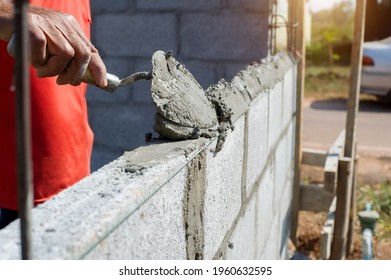 Masonry Worker Make Concrete Wall By Cement Block And Plaster At Construction Site