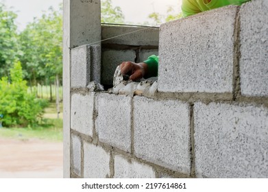 Masonry Worker Make Concrete Wall By Cement Block And Plaster At Construction Site