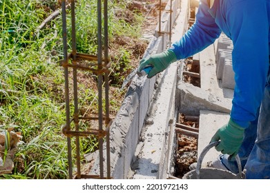 Masonry Worker Make Concrete Wall By Cement Block And Plaster At Construction Site