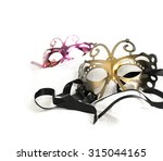 Masquerade carnival masks against a white background. Concept image for traditional New Years Eve party with ribbon and accommodation for copy space.