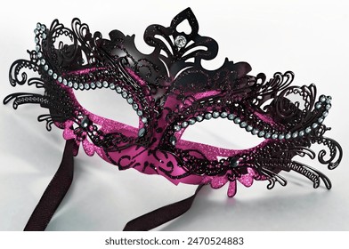 A masquerade eye mask in pink and black isolated on a white background - Powered by Shutterstock