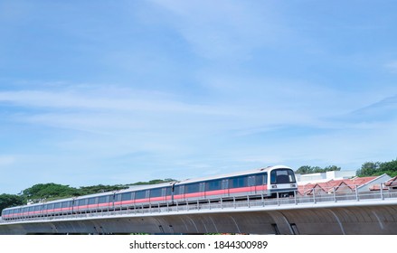 Mass Rapid Train MRT Travels On The Track A Blue Sky Background