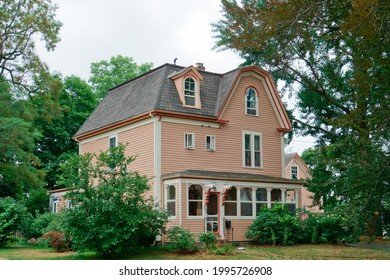 Massachusetts, United States-July 23, 2020: New England Style House With Steep Roof Shedding Heavy Snow In Winter Medway 