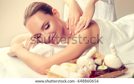 Massage and body  care. Spa body massage   woman hands treatment. Woman having massage in the spa salon for beautiful girl
