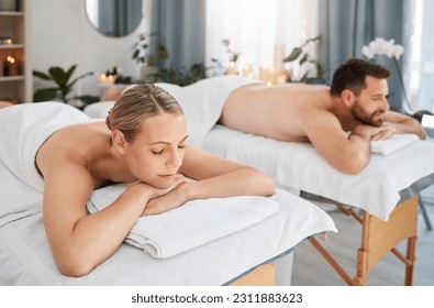 Massage, calm and peaceful couple lying in spa for wellness treatment or at a luxury resort or vacation. Bed, zen and relaxing partners indoors or stress relief or physical therapy and body care - Powered by Shutterstock