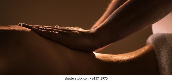 Massage closeup with hands of professional masseur