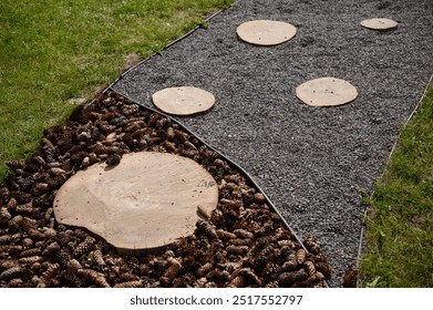 Massage eco-trail with materials of different textures: pine cones, tree cuts, small stones. Tactile trail in park for walking barefoot. Prevention of flat feet, strengthening immune system.  - Powered by Shutterstock