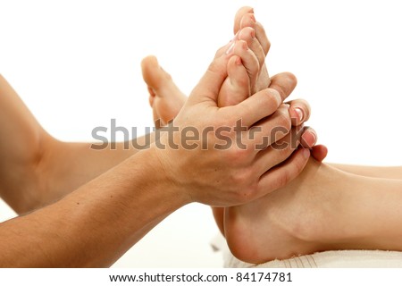 massage foot female close-up isolated on white background