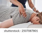 Massage, hands and physiotherapist with person, back and healing of pain of patient, healthcare and injury. Wellness, chiropractor and help for relief of tension, expert and physiotherapy in clinic