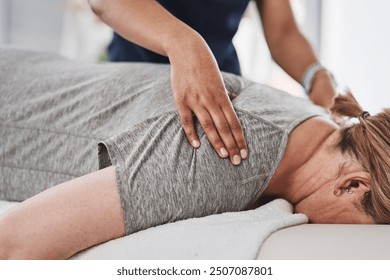 Massage, hands and physiotherapist with person, back and healing of pain of patient, healthcare and injury. Wellness, chiropractor and help for relief of tension, expert and physiotherapy in clinic - Powered by Shutterstock