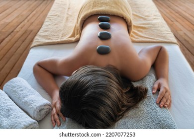Massage with hot stones for young girl in spa center - Shutterstock ID 2207077253