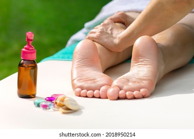 Massage of legs, female feet with oil, stones outdoors. Close up photo of woman foot and therapist's hands of masseur, massagist. Professional physiotherapist. Unrecognisable person is lying, relaxing - Powered by Shutterstock