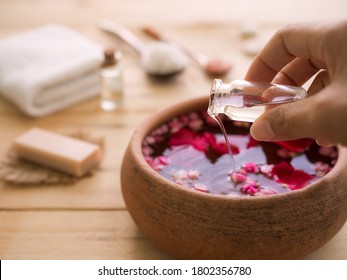 Massage Oil Spa With Hand Woman Pour Coconut Oil In To Aromatic Essential Smell Rose With Image Of Soap, Towel, Massage Oil, Salt Spa, Candle.zen.bath Aroma Therapy Spa Set Oriental.