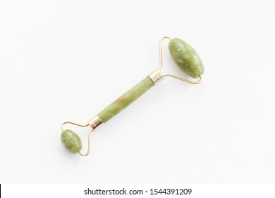 Massage roller for the face with two heads of jade stone. Health care concept