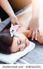 Massage And Spa. Relaxing Body Massage For Beautiful Asian Young Woman. Unrecognizible Female Masseur Massaging Korean Girl's Back. Luxury Spa, Body Care, Healthy Lifestyle. Vertical Photography.