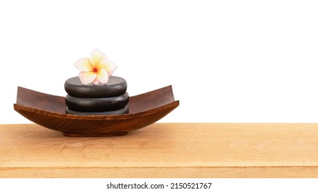 Massage stones and plumeria flower isolated on white background with clipping path.