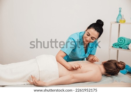 a massage therapist massages back client relax relaxation osteopathy recovery