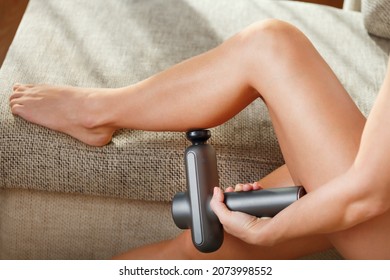 Massage of women's legs with a shock massage device. Shock self-massage to restore fascia muscles and trigger points
