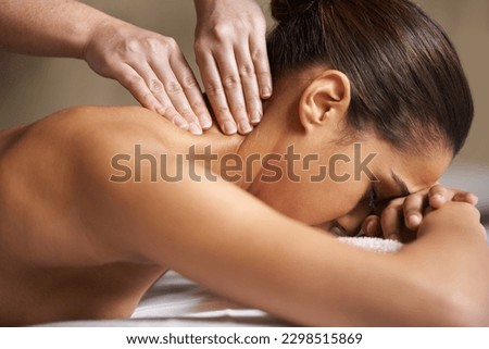 Massaging away all the worries and stress. a young woman enjoying a back massage at a spa.