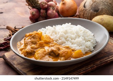 Massaman Curry with Chicken and Potatoes with cooked rice in a plate - Powered by Shutterstock